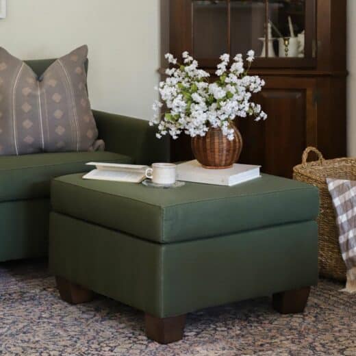 Our Verona ottoman in green with household items on it