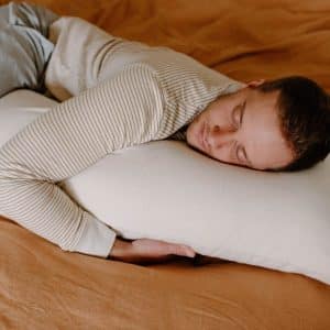 Organic Wool Latex Body Pillow - man hugging pillow