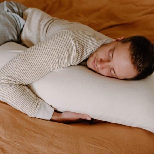 Organic Wool Latex Body Pillow - man hugging pillow