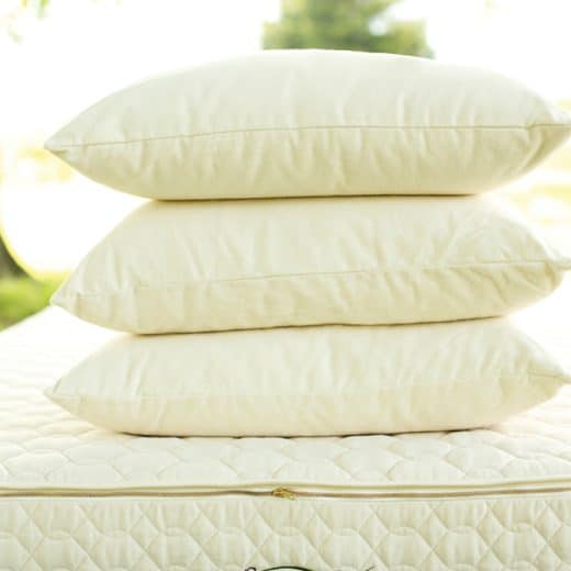 Organic wool pillow - three medium-firm pillows stacked on Savvy Rest mattress
